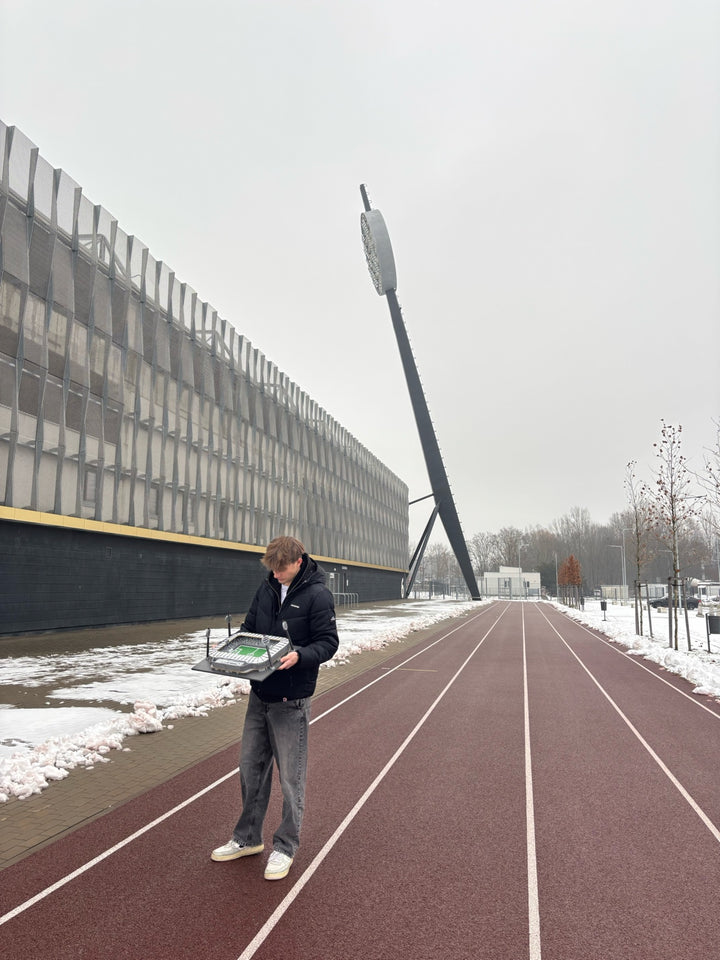 Šimon with the Malšovická Arena model beside the stadium and one of its floodlight towers