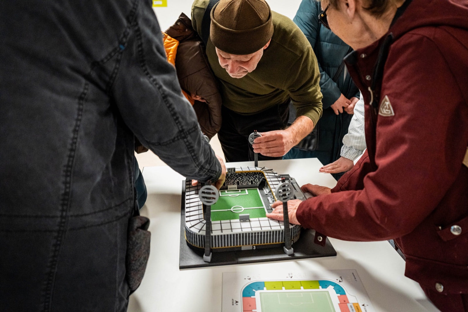 Club programme participants beside the tactile XL model of Malšovická Arena