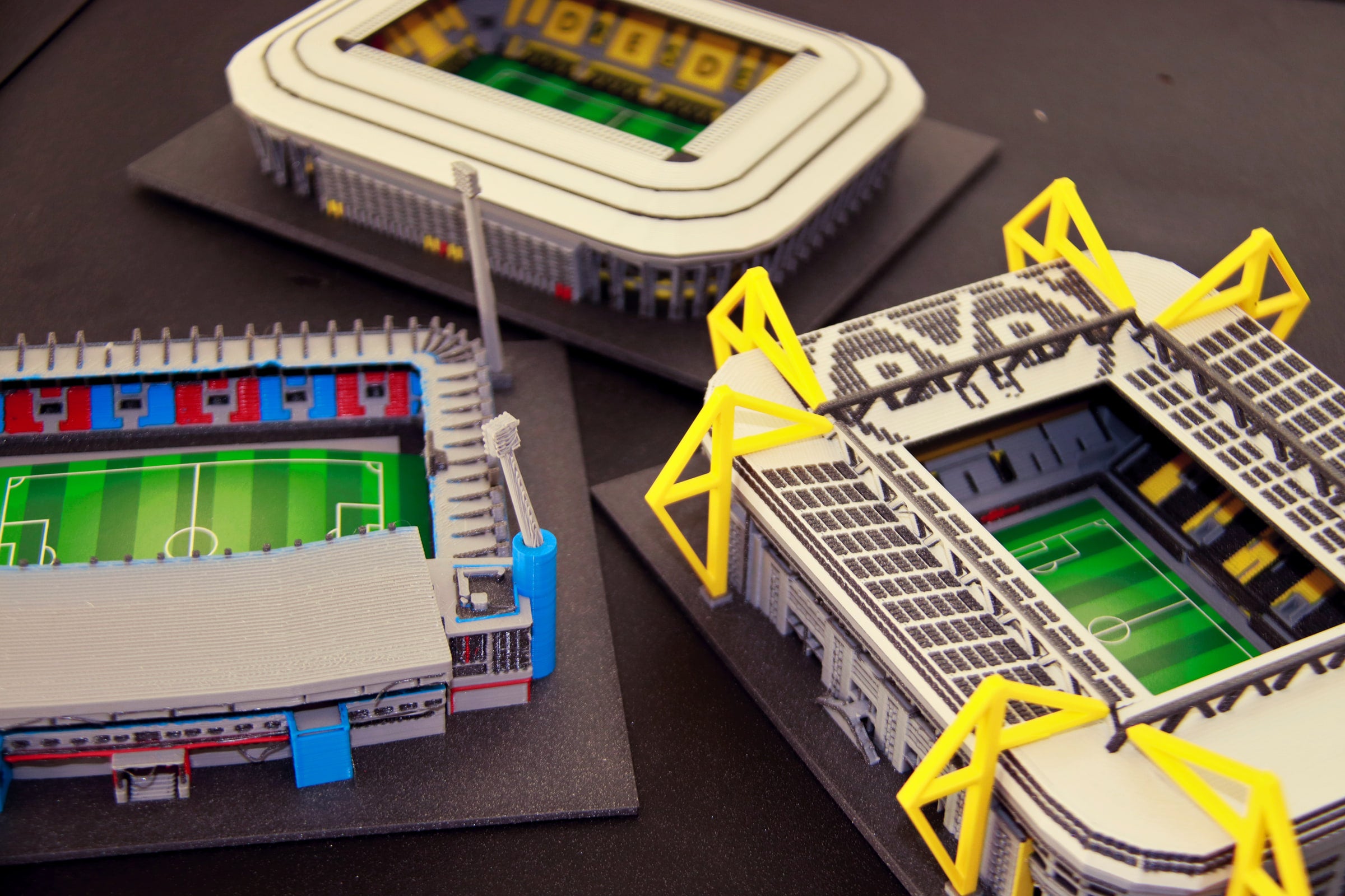 Coloured StadiArt models of the stadiums in Pilsen, Dortmund and Dresden